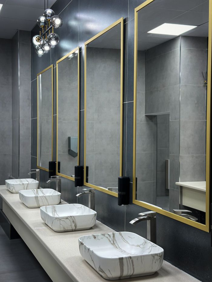 gallery-1 Sleek bathroom interior featuring marble sinks and stylish mirrors.